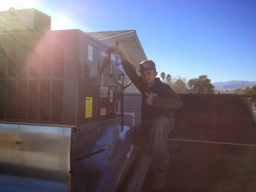 HVAC technician performing HVAC Inspection on a rooftop unit in Gadsden